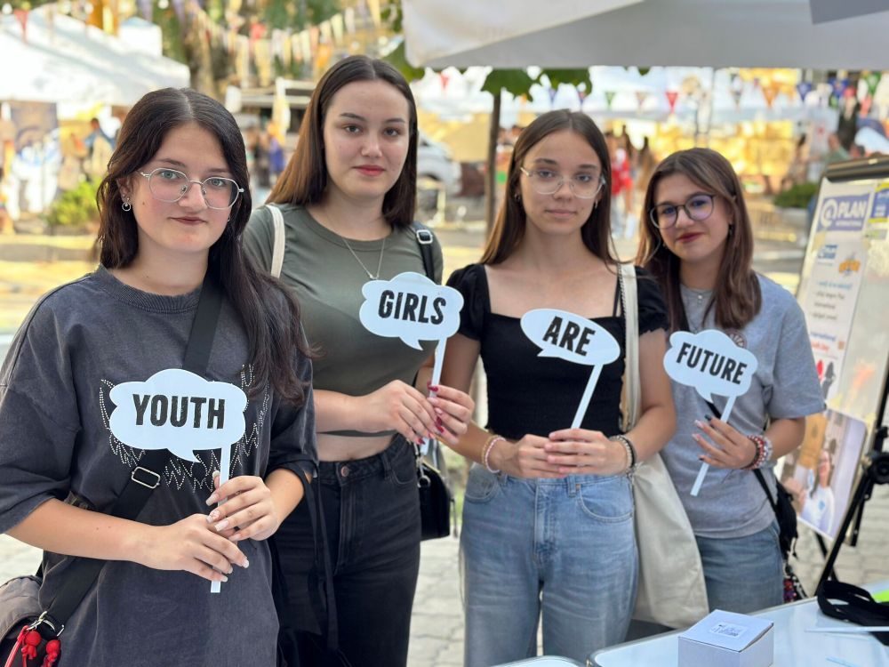 Four girls holding signs that say 'youth girls are future.'